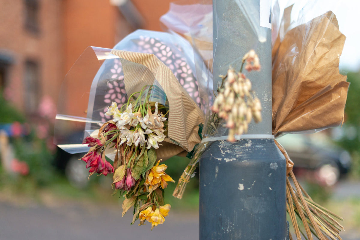 Flowers left as a quiet tribute, evoking memorial bouquets laid in remembrance